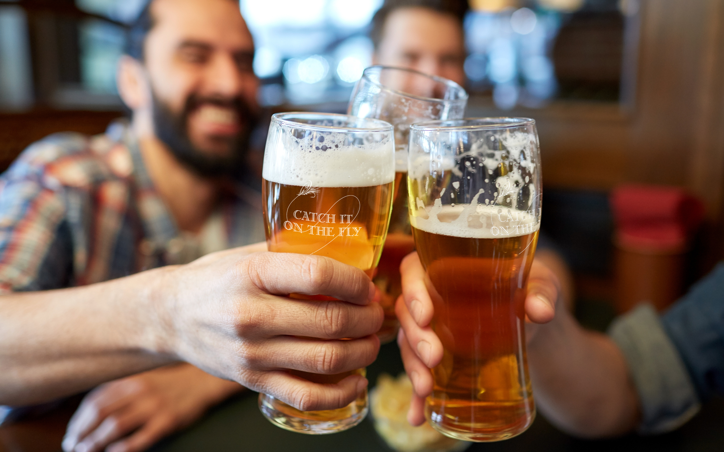 People cheers with beer pints